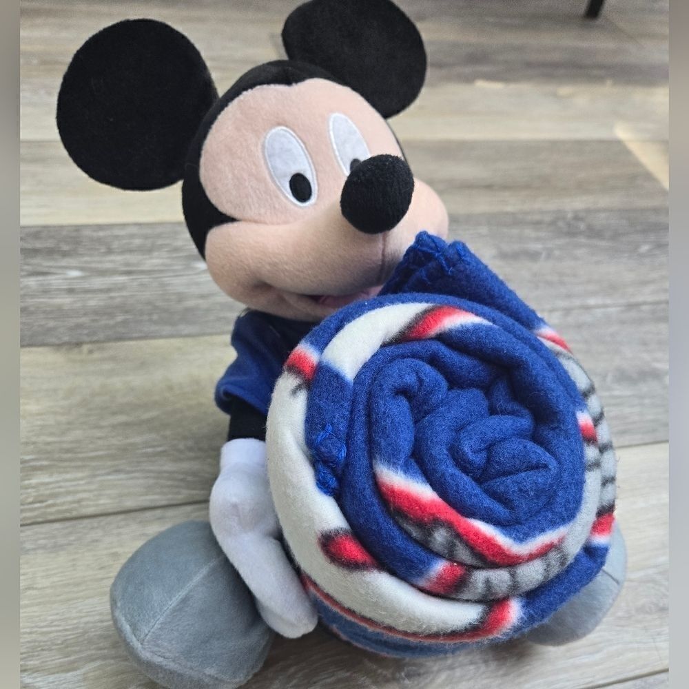 Giants blanket with Disney's Mickey plush hugging it